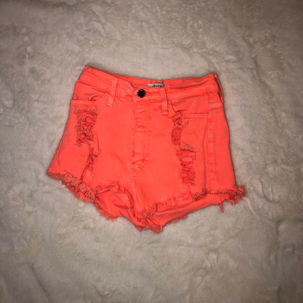 neon orange ripped jean shorts